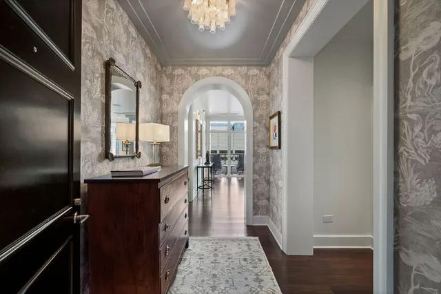 a view of a hallway with wooden floor and furniture