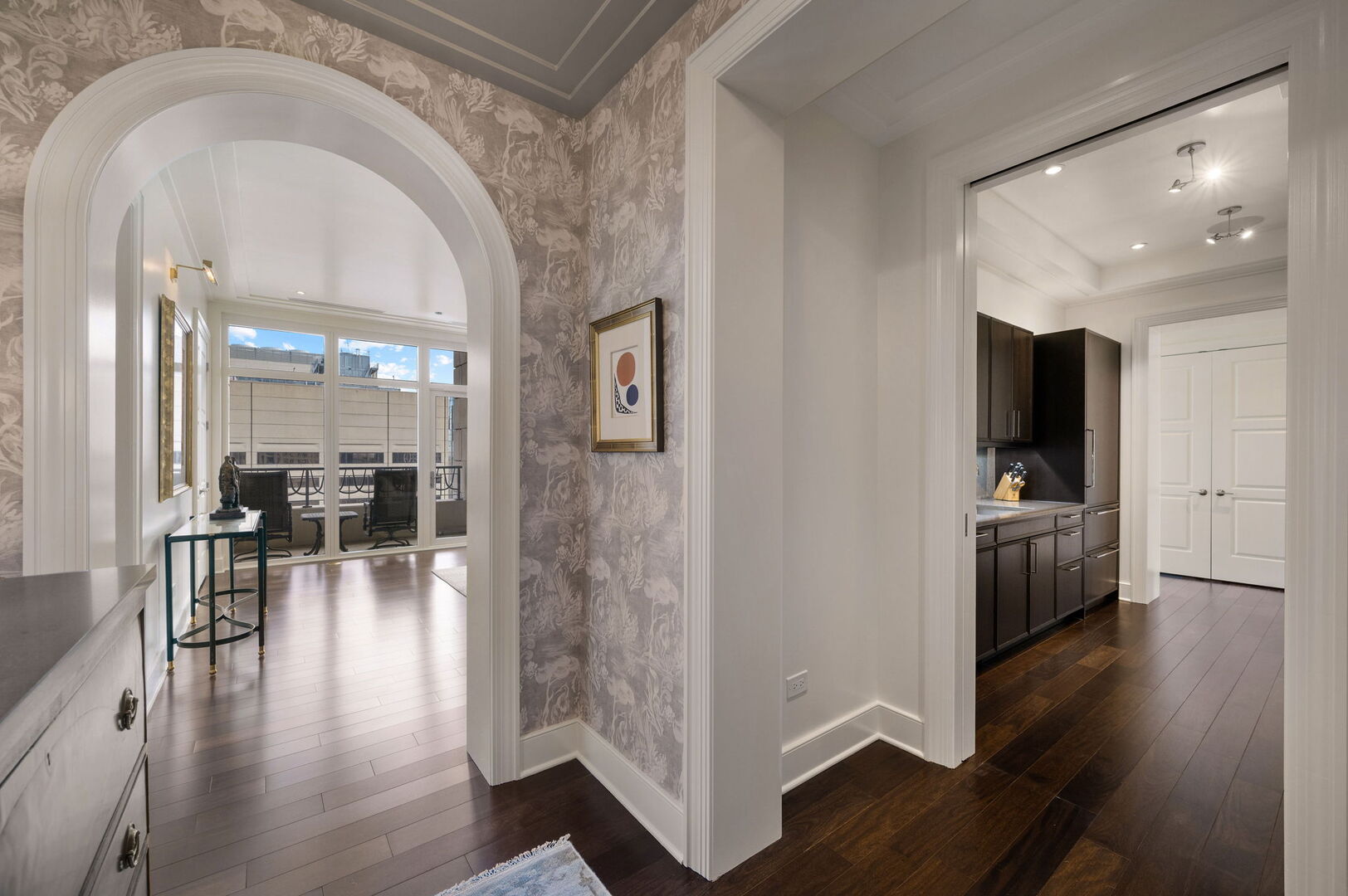 118 East Erie Street, Unit 28F Chicago, IL 60611 - Photo 5 of 31 a view of a hallway with wooden floor and furniture