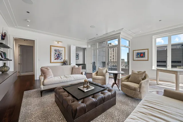 a dining room with furniture a chandelier and window