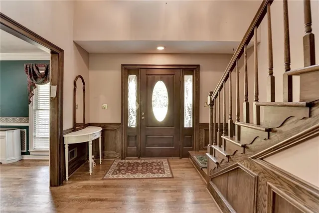 a view of a hallway with wooden floor and staircase
