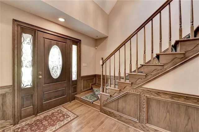 a view of a hallway with wooden floor and staircase