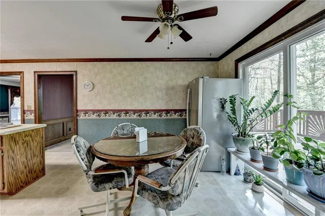 a dining room with furniture potted plants and wooden floor