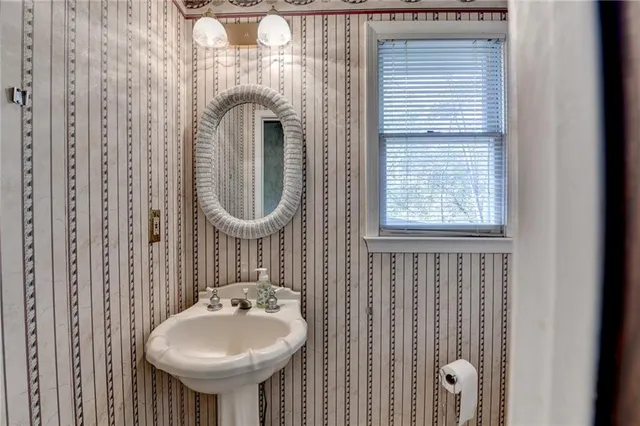 a bathroom with a sink a mirror and a window