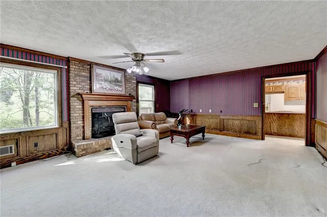 a view of a livingroom with furniture and a fireplace