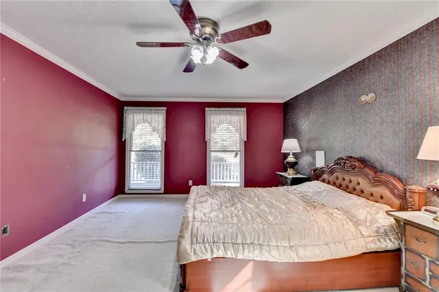 a bedroom with a large bed and a chandelier