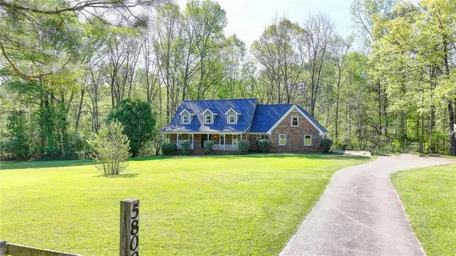 a house view with swimming pool next to a yard