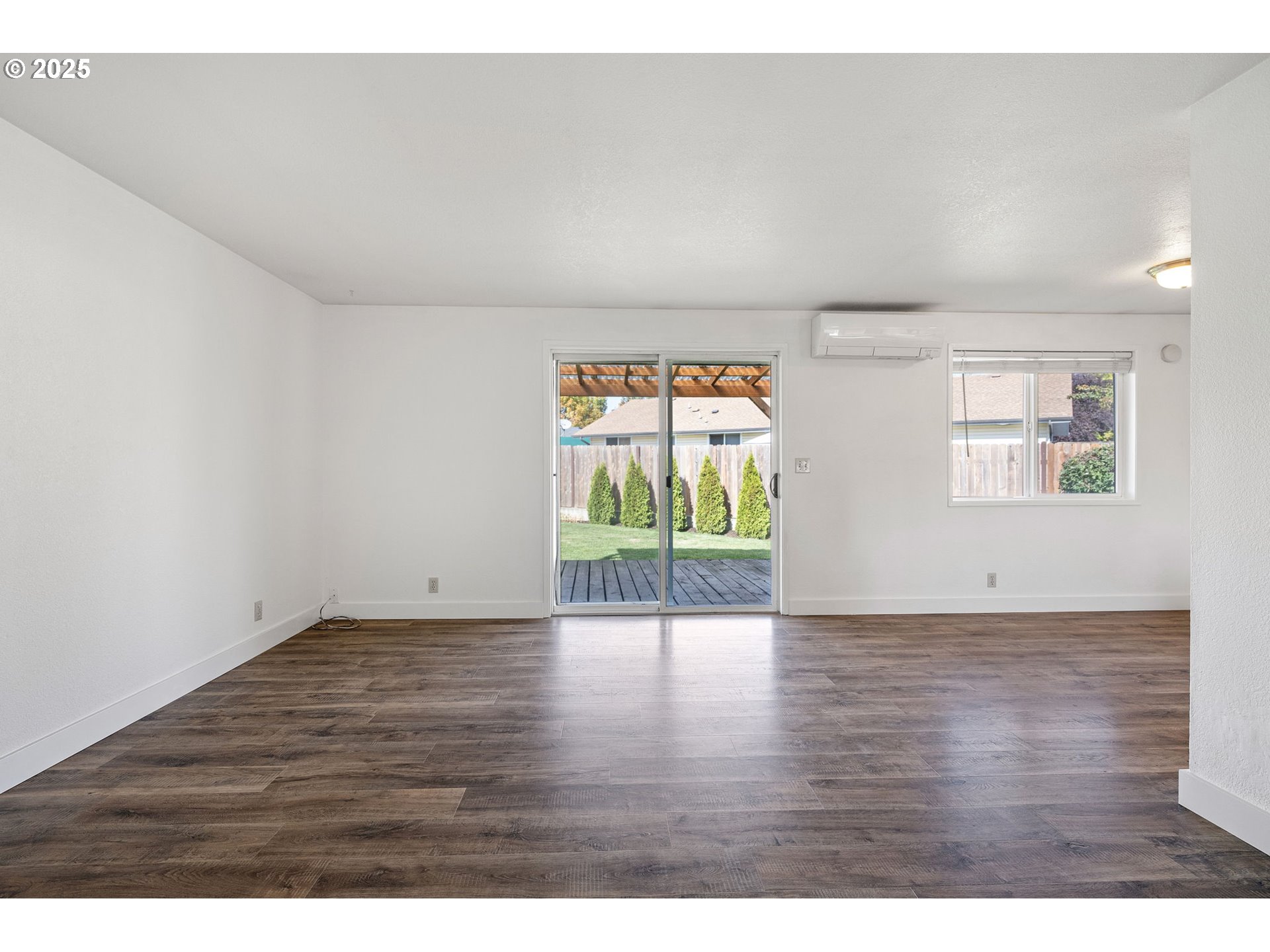 872 West N Street Springfield, OR 97477 - Photo 3 of 28 a view of an empty room with wooden floor and a window