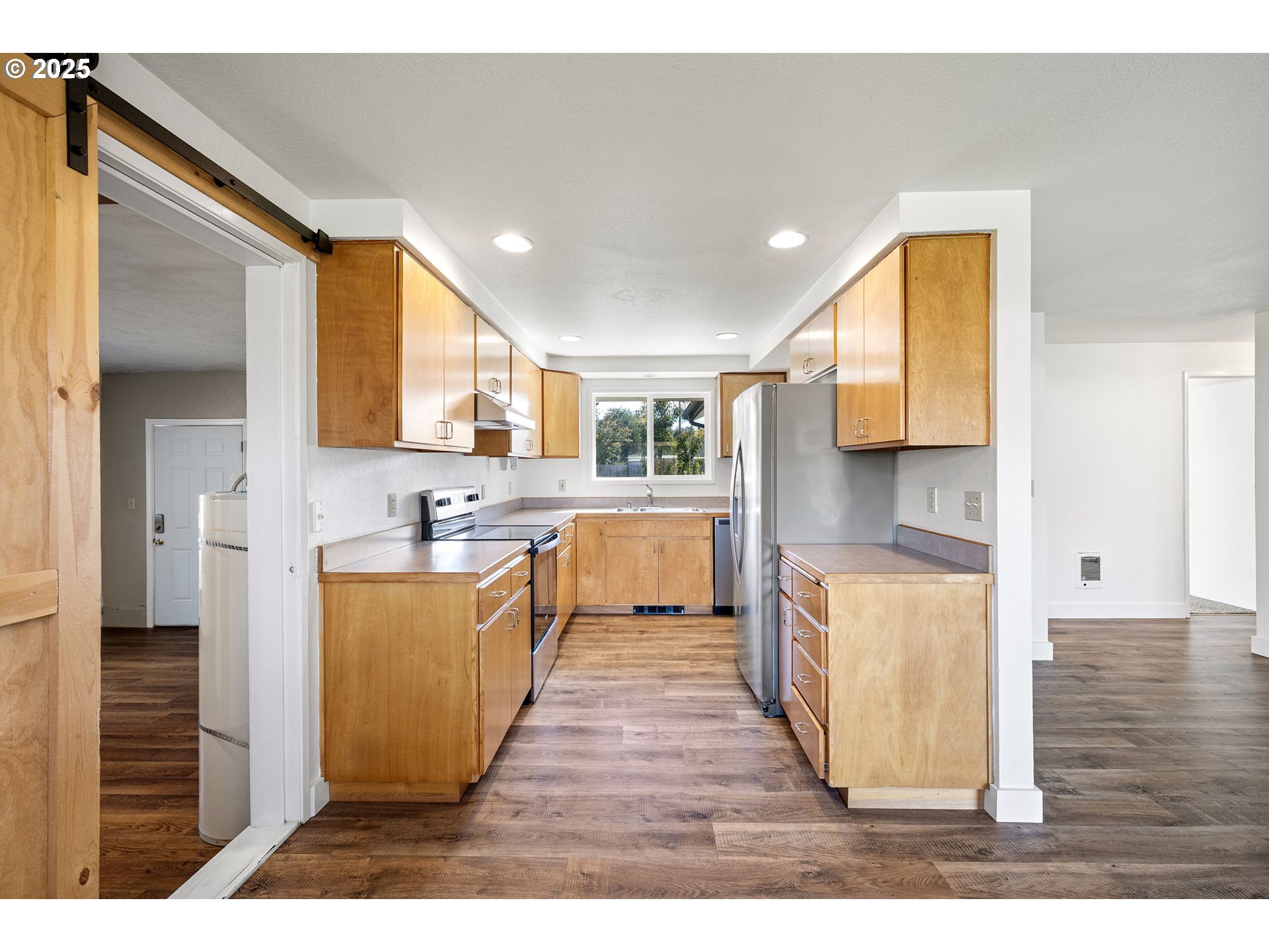 872 West N Street Springfield, OR 97477 - Photo 6 of 28 a large kitchen with stainless steel appliances granite countertop a stove a sink and a refrigerator