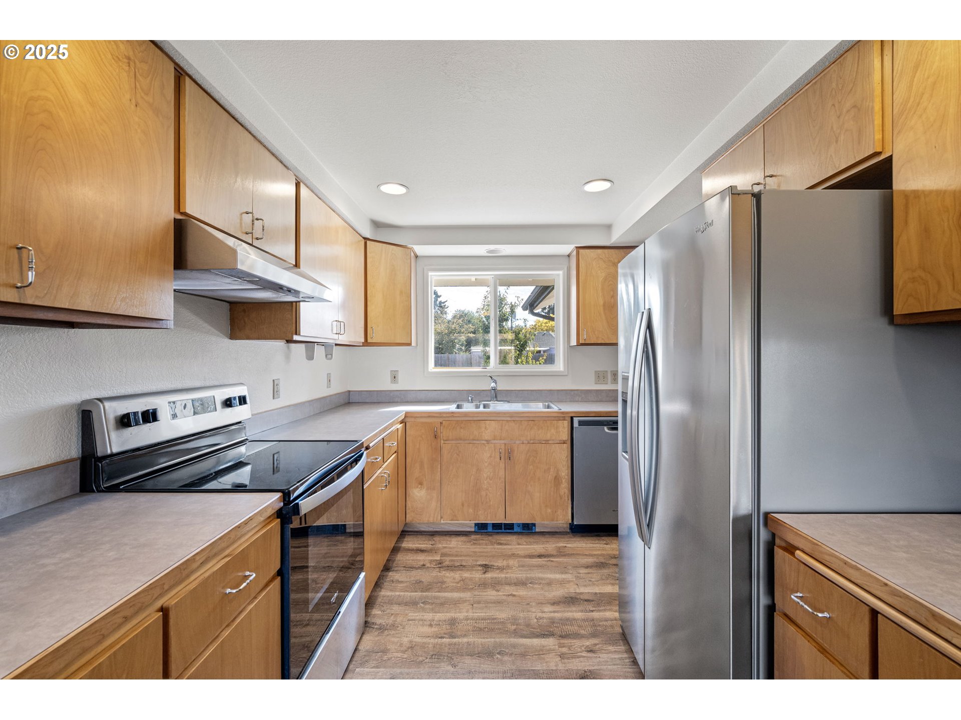 872 West N Street Springfield, OR 97477 - Photo 7 of 28 a kitchen with stainless steel appliances granite countertop a refrigerator a sink and a stove