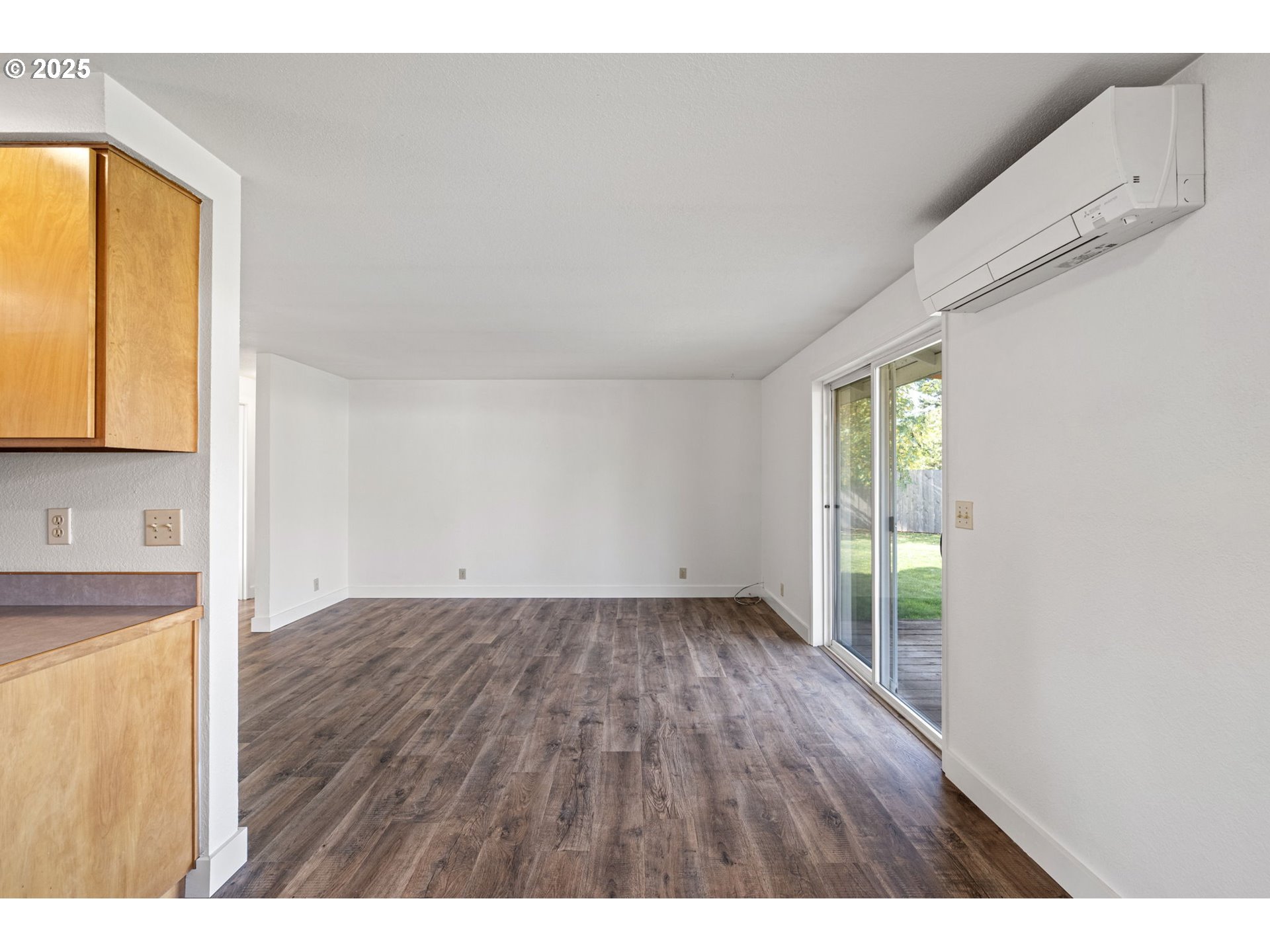 872 West N Street Springfield, OR 97477 - Photo 10 of 28 a view of an empty room with wooden floor and a window