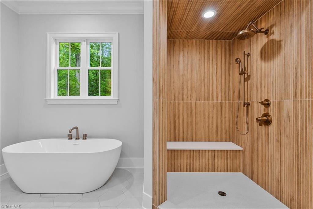 6903 Tully Court Oak Ridge, NC 27310 - Photo 5 of 33 custom tile work and freestanding tub in primary bath