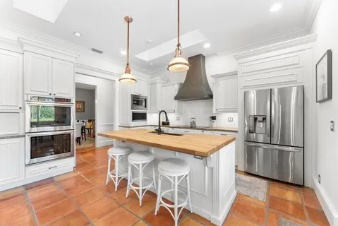 a living room with furniture a rug and a flat screen tv