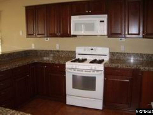 4387 Rancheria Road Fallon, NV 89406 - Photo 6 of 6 a kitchen with a stove and a cabinets