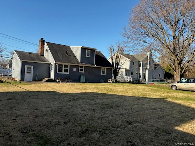 499 Old Country Road Deer Park, NY 11729 - Photo 20 of 21 a front view of a house with a yard
