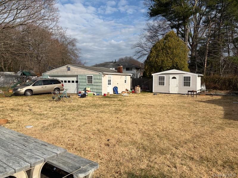 499 Old Country Road Deer Park, NY 11729 - Photo 21 of 21 a white house that has a tree in front of it