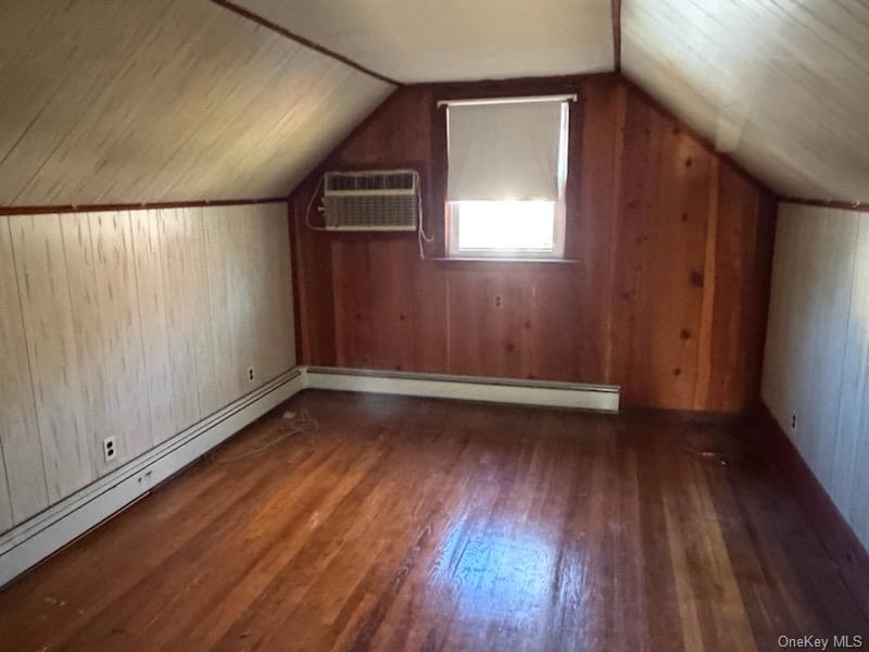 499 Old Country Road Deer Park, NY 11729 - Photo 7 of 21 a view of empty room with wooden floor and fan