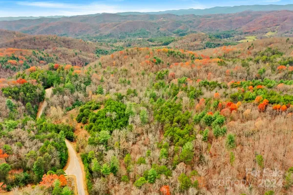 an aerial view of mountain with an ocean