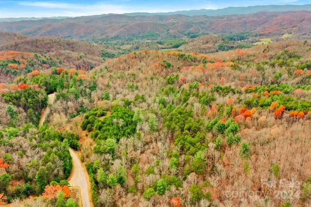 an aerial view of mountain with an ocean