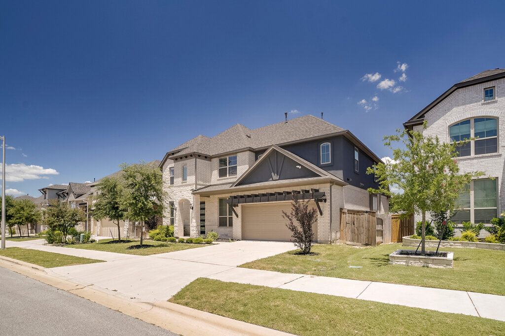 2920 Hadley Way Leander, TX 78641 - Photo 1 of 20 A well-manicured lawn and driveway lead to this charming two-story brick residence.