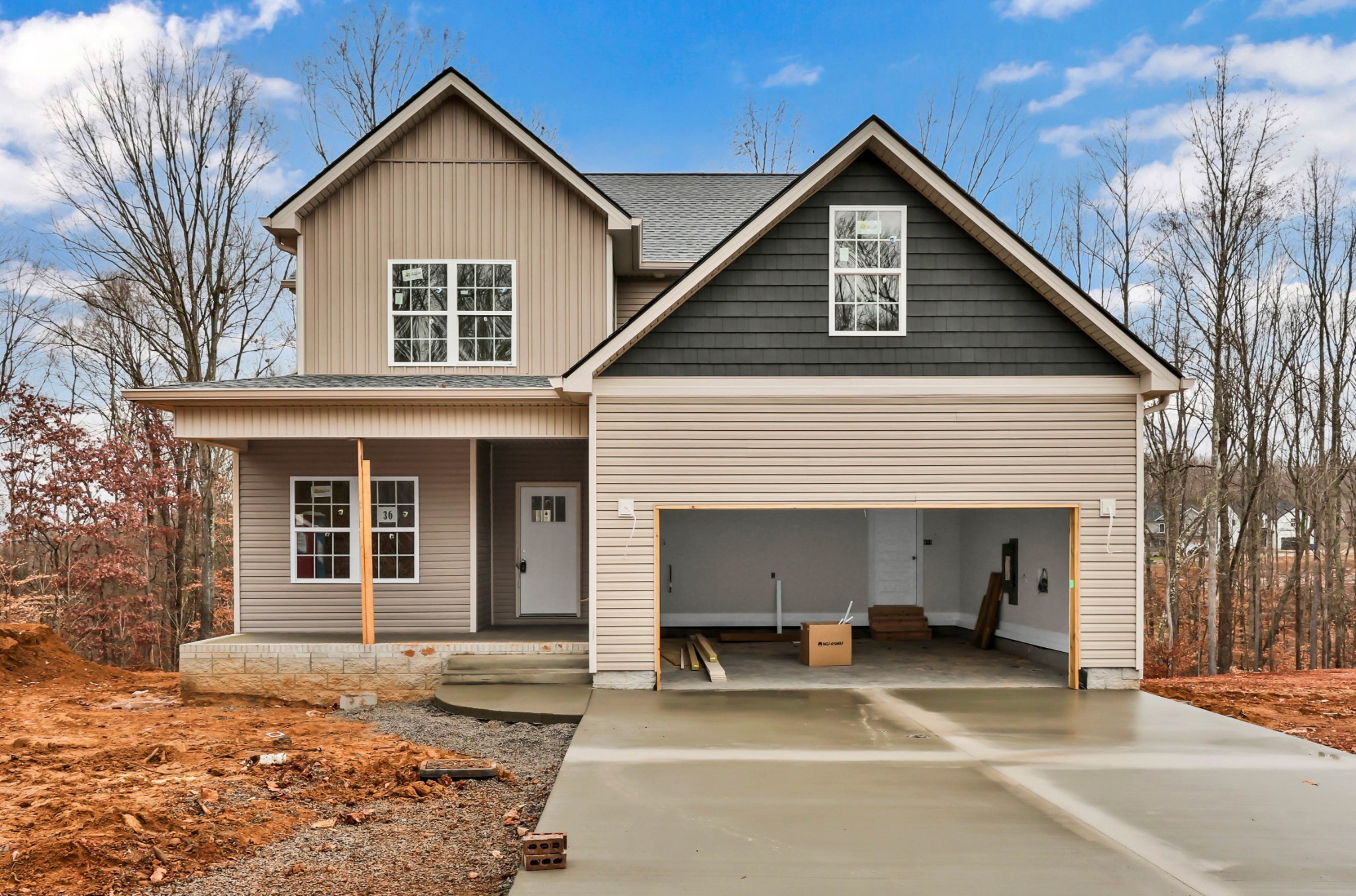 a view of a house with a patio and a yard