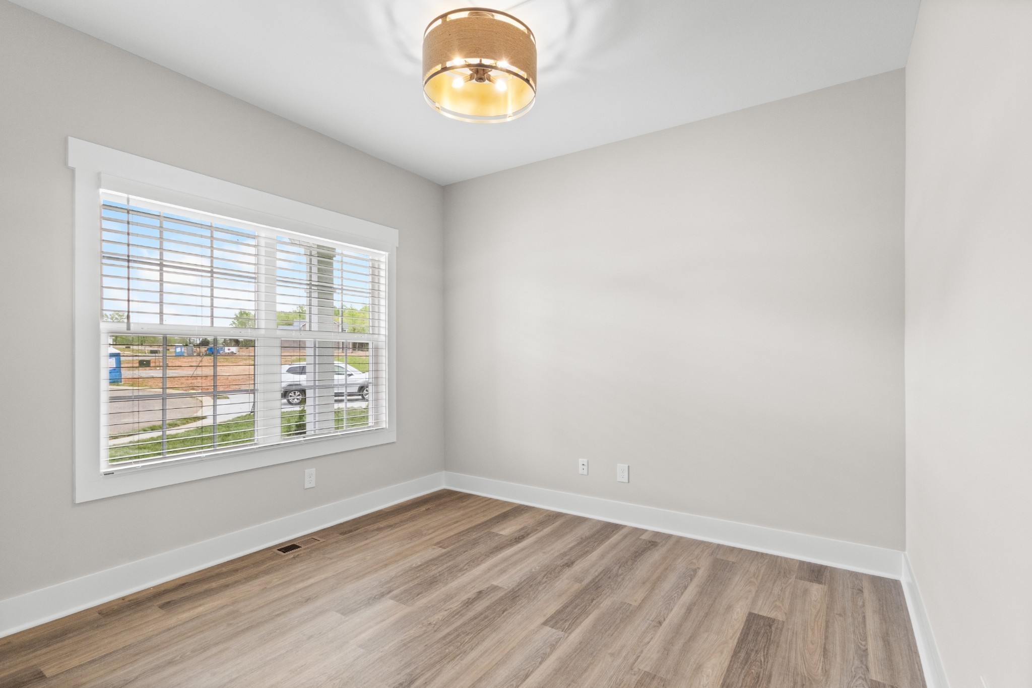 1228 Boulder Pass Road Clarksville, TN 37040 - Photo 3 of 26 an empty room with wooden floor and windows