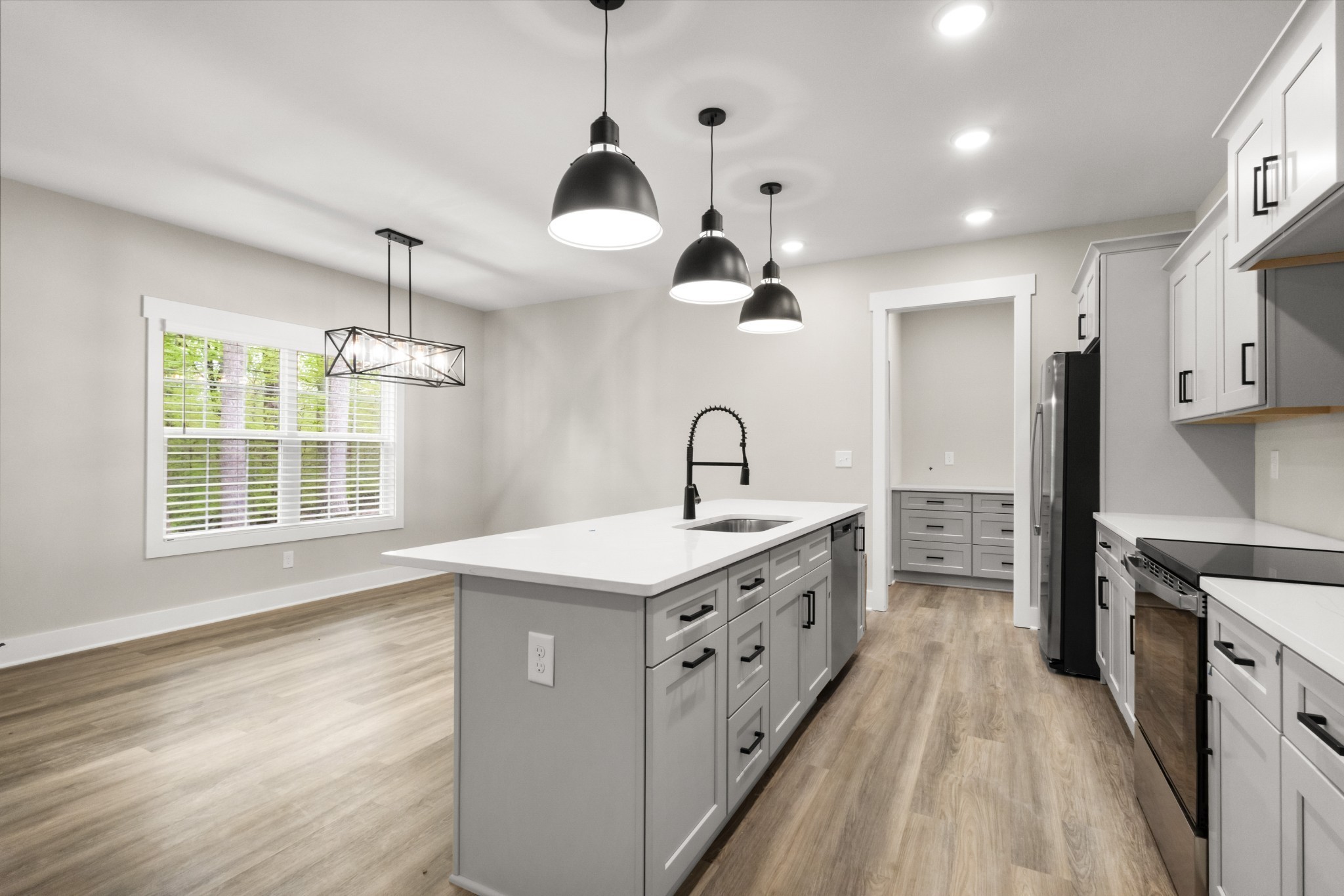 1228 Boulder Pass Road Clarksville, TN 37040 - Photo 8 of 26 a kitchen with stainless steel appliances a sink stove and refrigerator