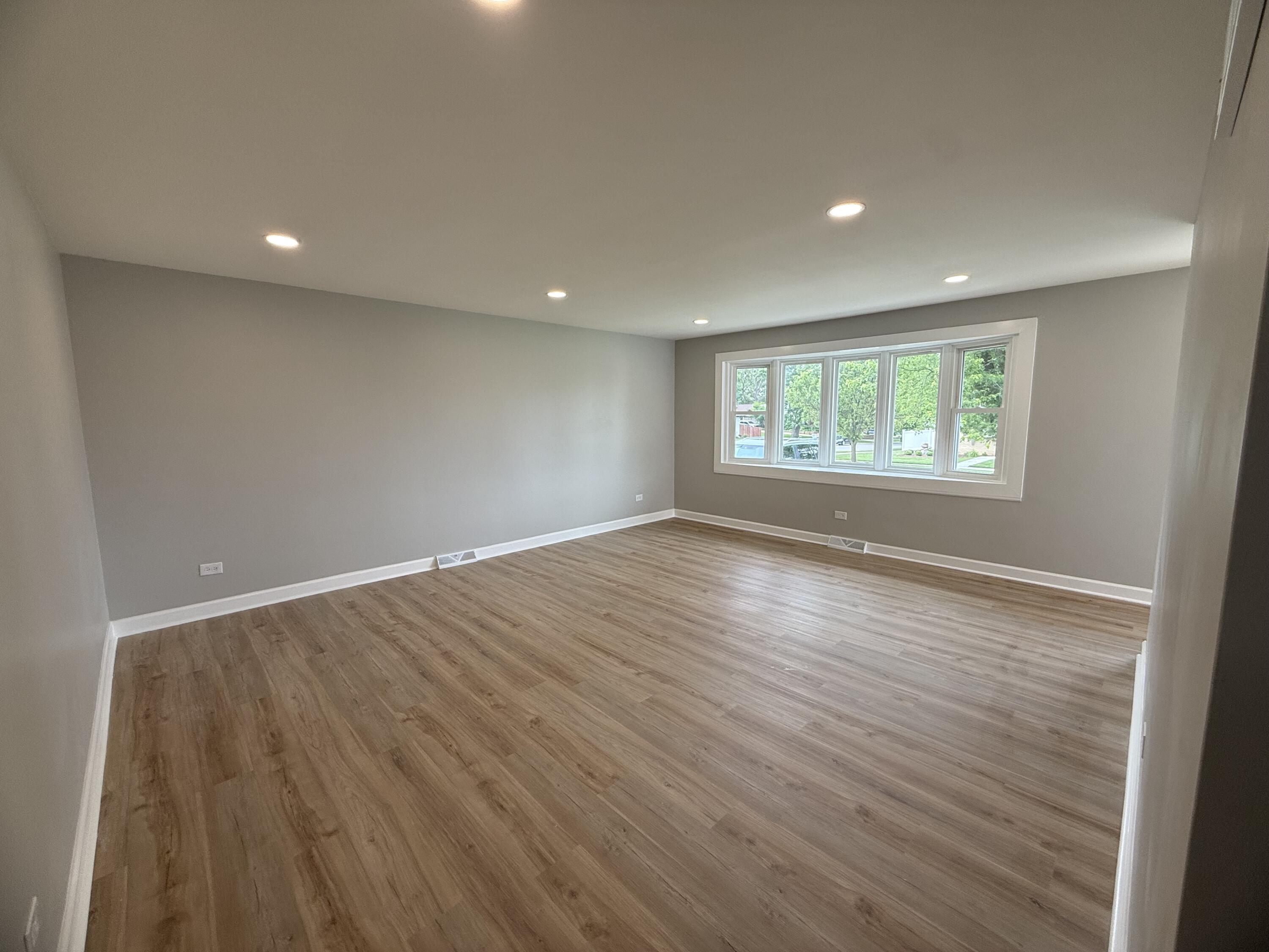 408 Cherry Hill Road Dyer, IN 46311 - Photo 5 of 31 an empty room with wooden floor and windows