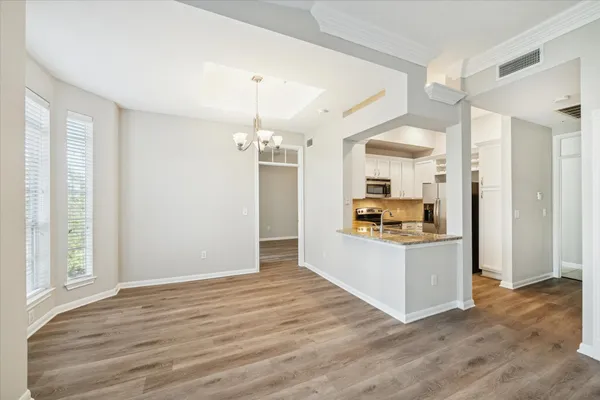 a view of a kitchen cabinets and a wooden floor
