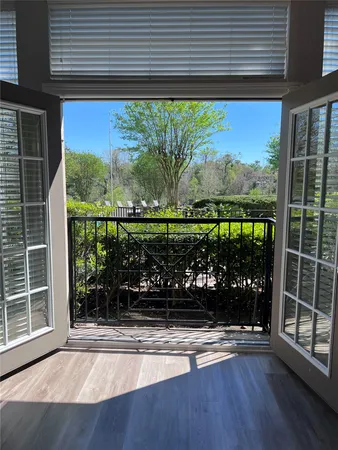 a view of a room that has a large window and swing