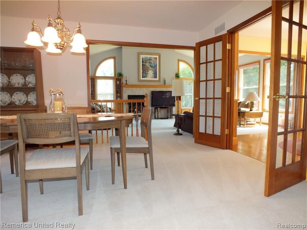 37297 Howard Road Farmington, MI 48331 - Photo 12 of 62 View Foyer to Dining Room with Natural Wood French Doors