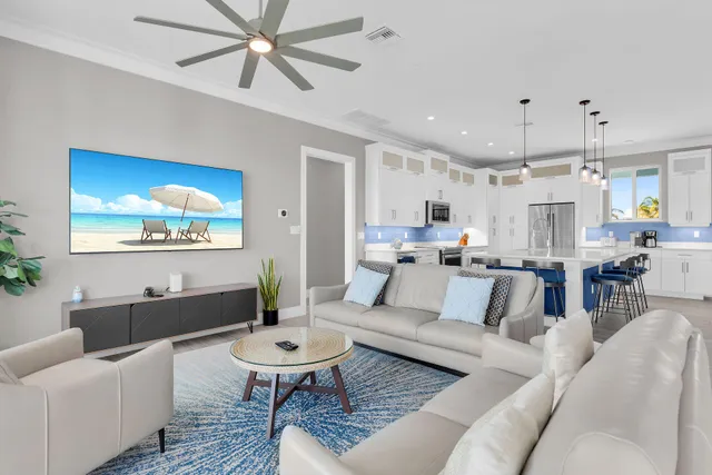 a living room with furniture a chandelier and a large window