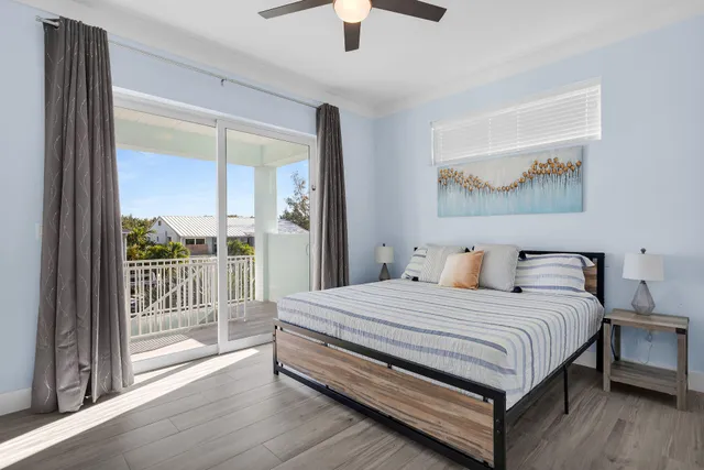 a bedroom with a bed and a large window