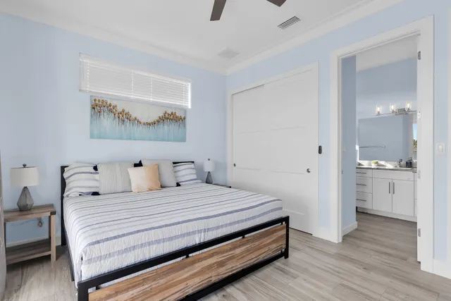 a bathroom with a granite countertop sink a toilet a mirror and shower