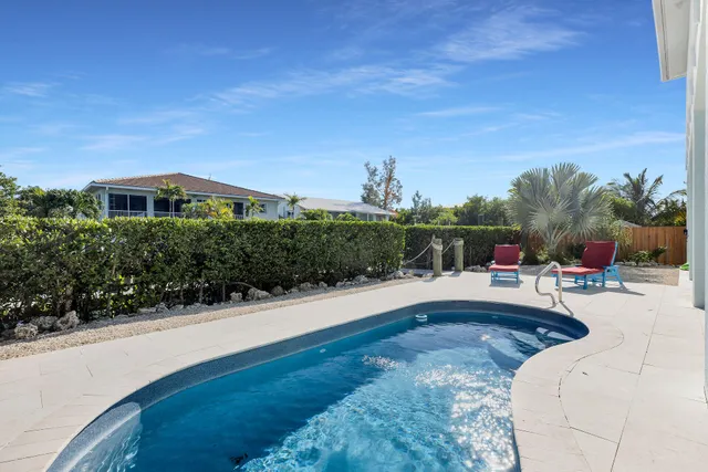 a backyard of a house with table and chairs