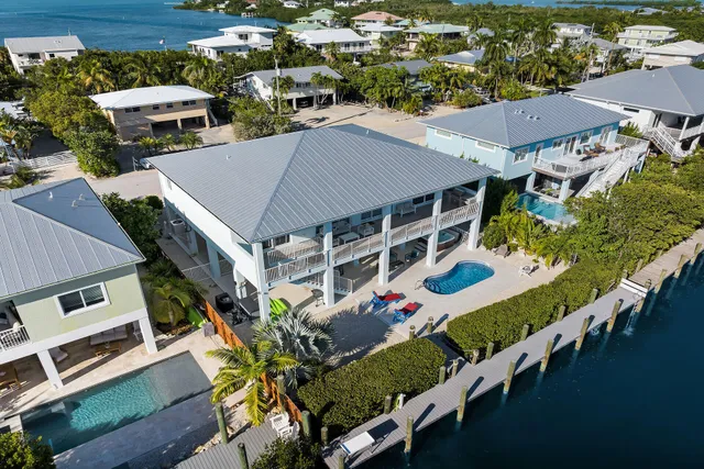an aerial view of a house with swimming pool patio and outdoor seating