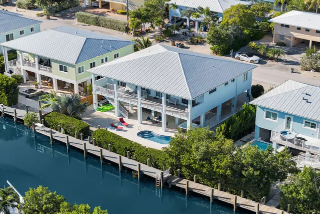 an aerial view of multiple houses with a yard