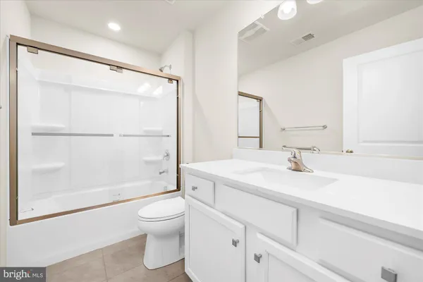 a bathroom with a sink a toilet and a large mirror