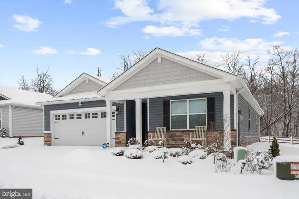a view of a house with snow in front of it