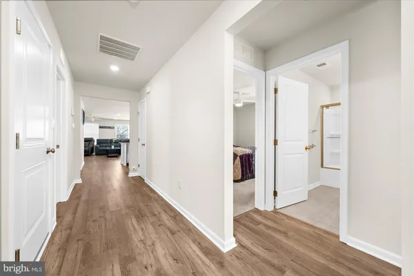 a view of a hallway view with wooden floor and staircase