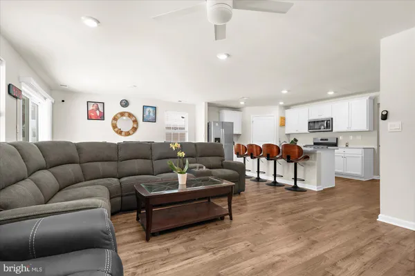 a living room with furniture and kitchen view