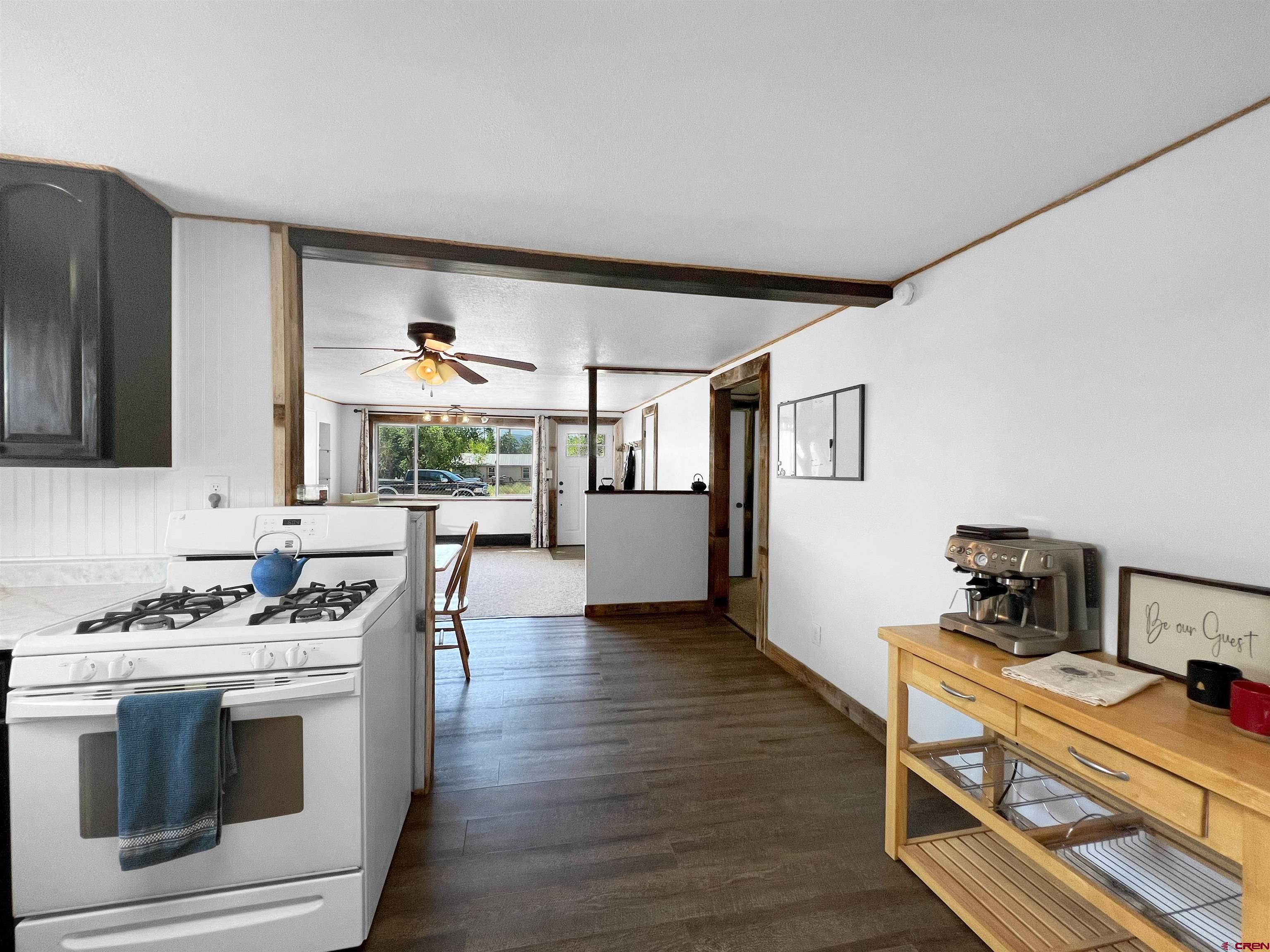 1002 East Carpenter Street Cortez, CO 81321 - Photo 12 of 42 a kitchen with stainless steel appliances granite countertop a stove and a refrigerator