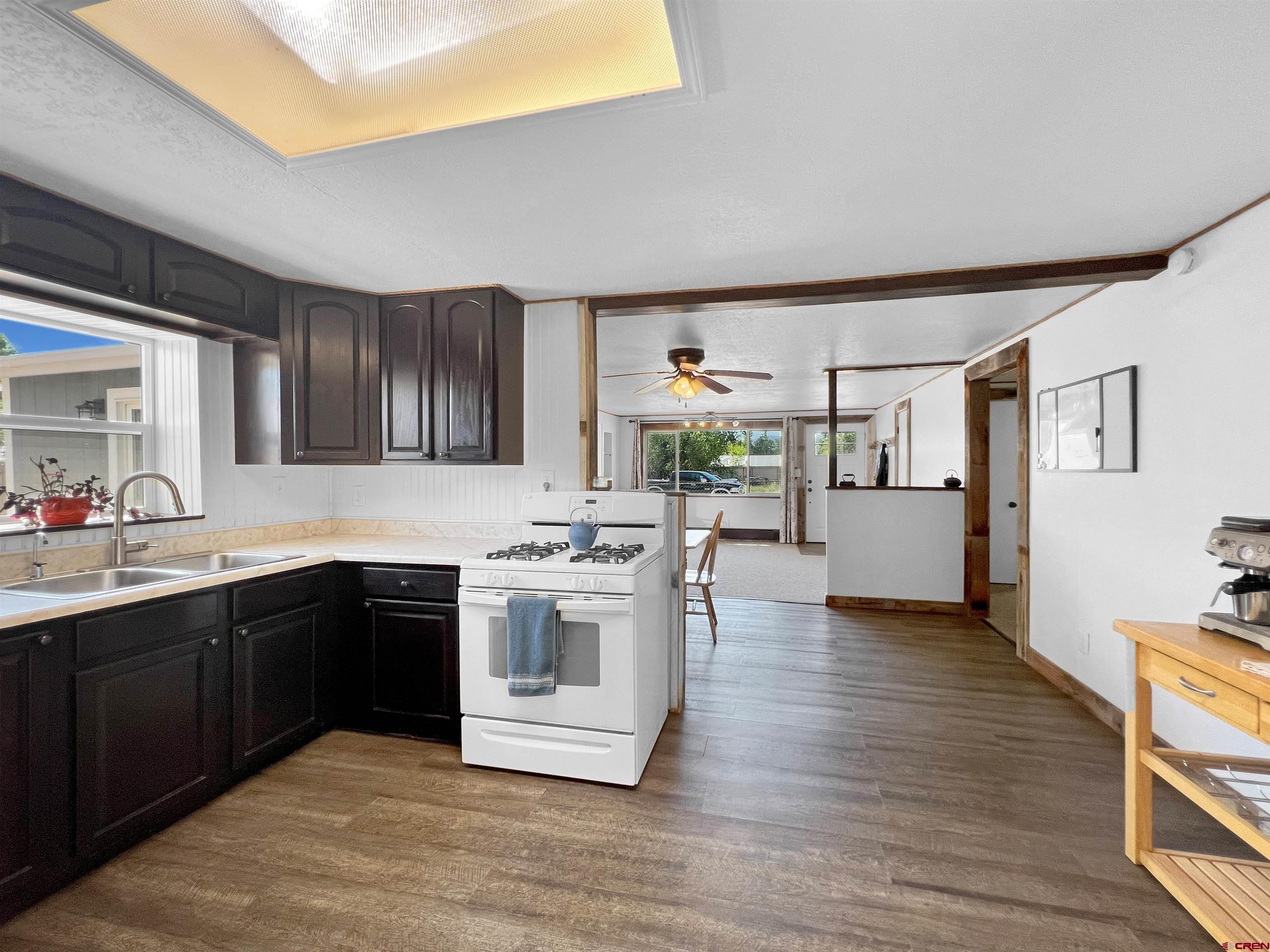 1002 East Carpenter Street Cortez, CO 81321 - Photo 13 of 42 a kitchen with stainless steel appliances granite countertop a sink and cabinets
