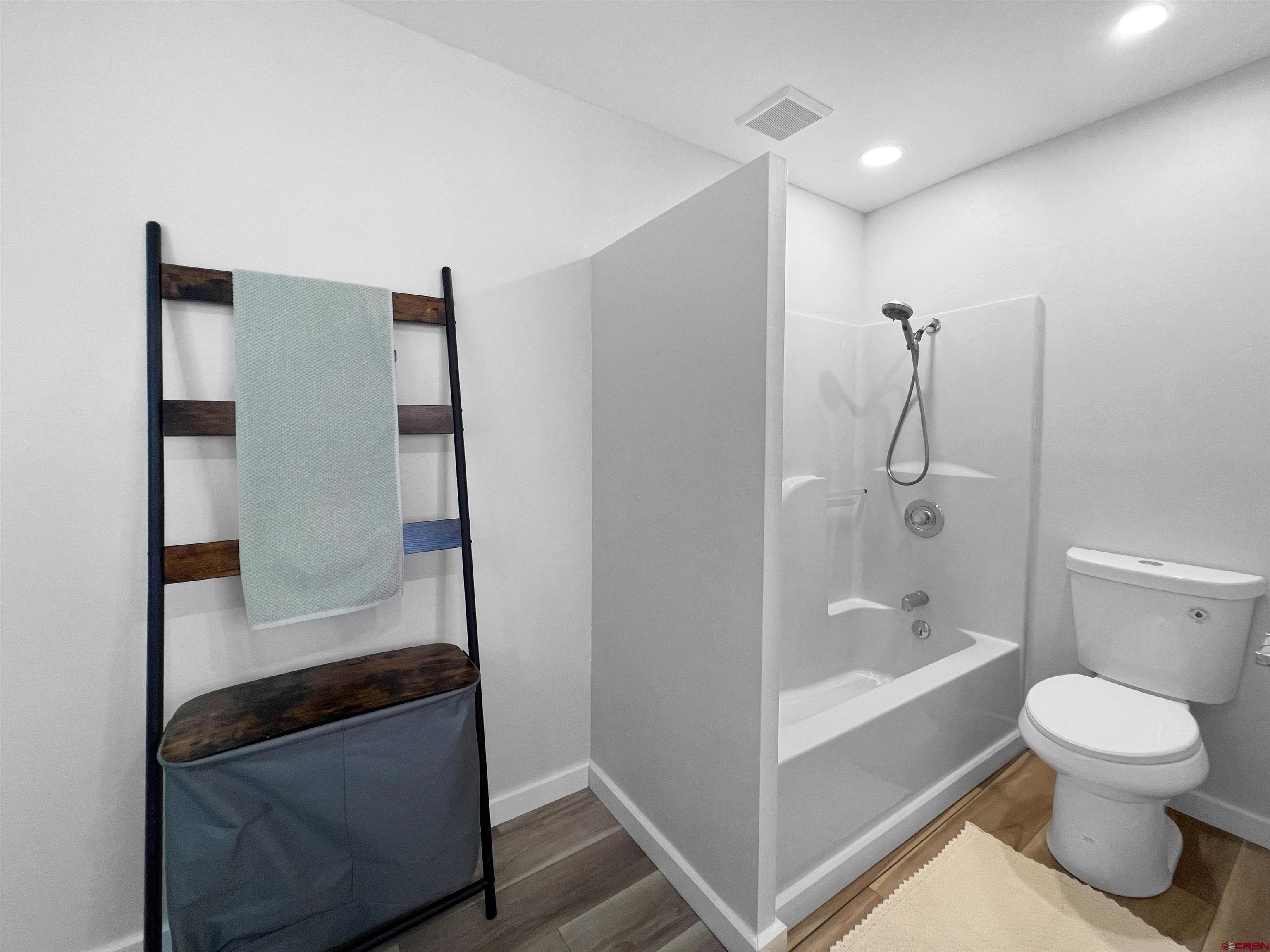 1002 East Carpenter Street Cortez, CO 81321 - Photo 21 of 42 a bathroom with a tub and a shower