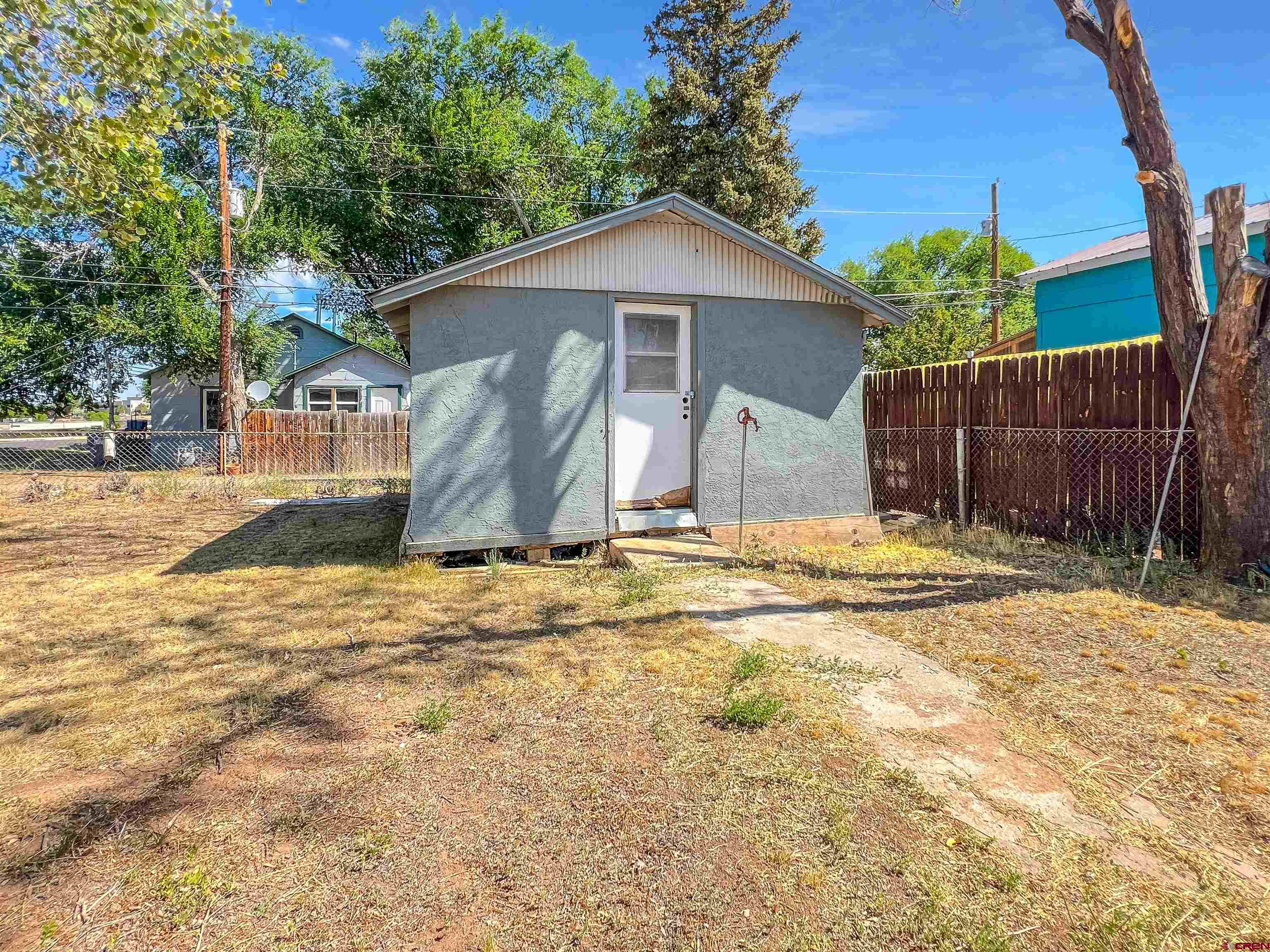 1002 East Carpenter Street Cortez, CO 81321 - Photo 35 of 42 a view of a house with a yard