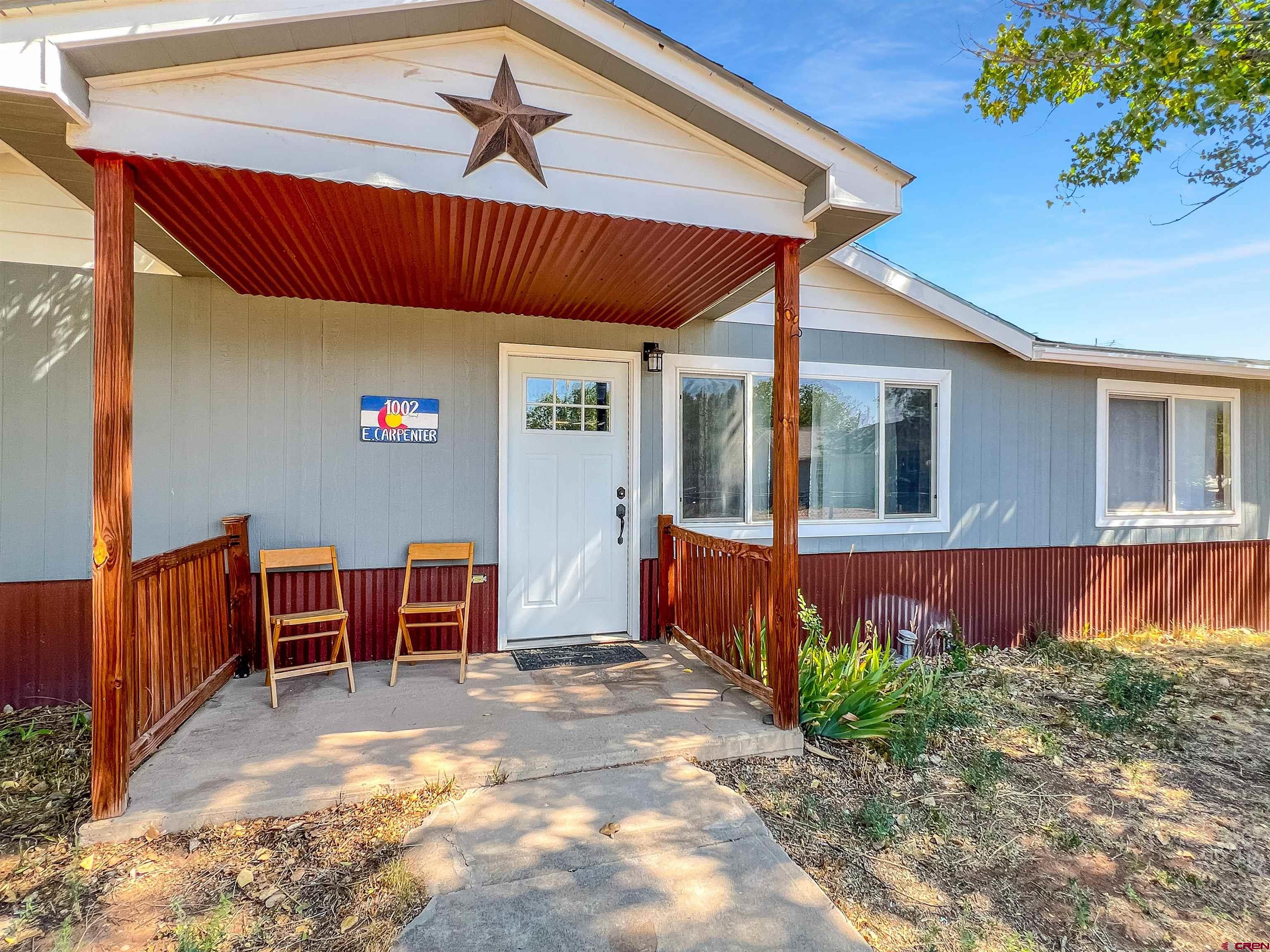 1002 East Carpenter Street Cortez, CO 81321 - Photo 39 of 42 a view of backyard with furniture and tub