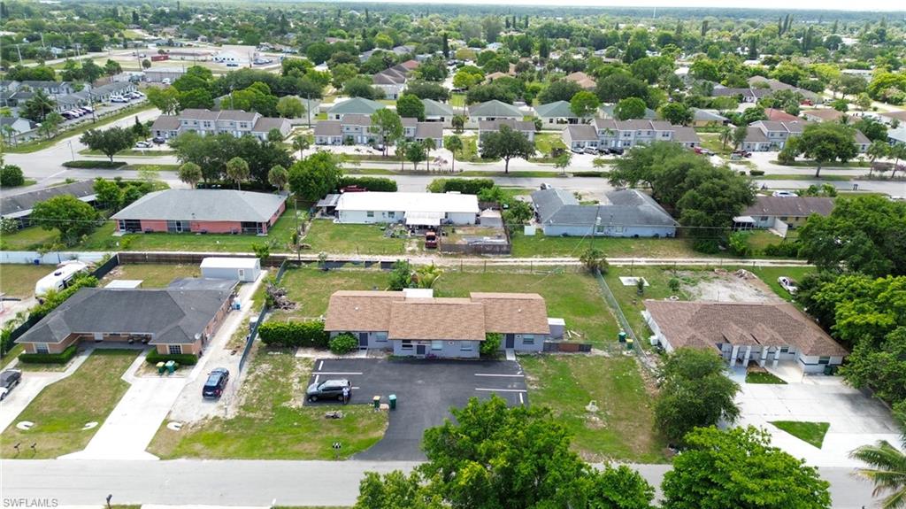 1940 48th Street Southwest Naples, FL 34116 - Photo 14 of 33 Aerial perspective showcasing multiple properties with paved driveways and surrounding mature landscaping