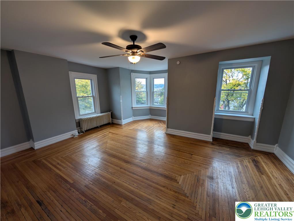 1027 Walnut Street, Unit 3 Allentown, PA 18102 - Photo 11 of 14 a view of an empty room with wooden floor and a window