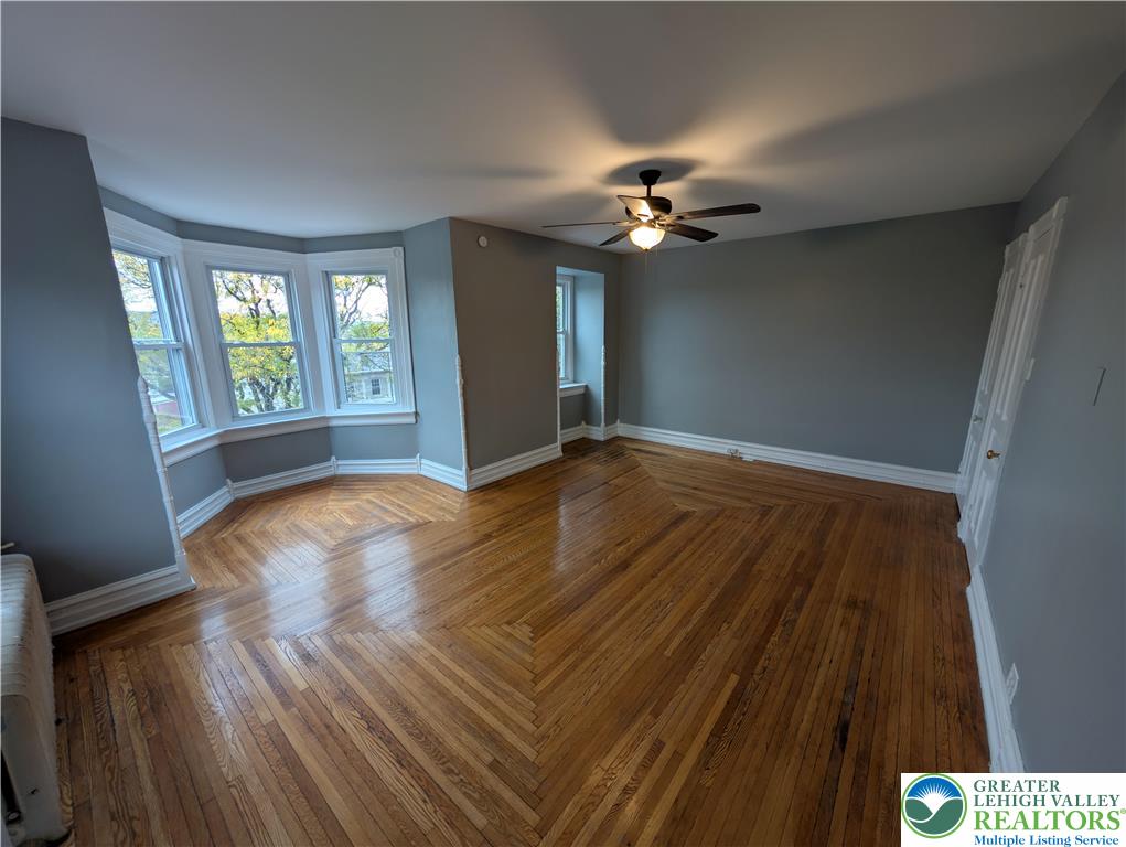 1027 Walnut Street, Unit 3 Allentown, PA 18102 - Photo 12 of 14 a view of empty room with wooden floor and fan