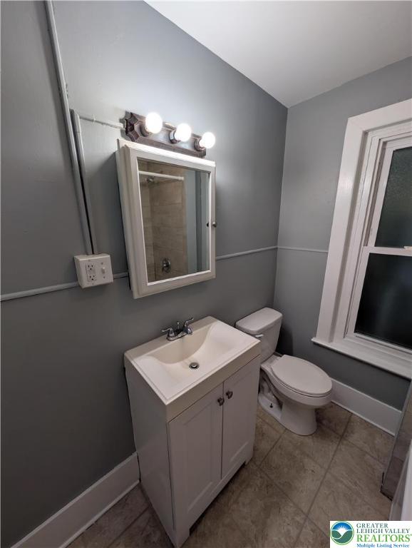 1027 Walnut Street, Unit 3 Allentown, PA 18102 - Photo 14 of 14 a bathroom with a sink a toilet a mirror and vanity