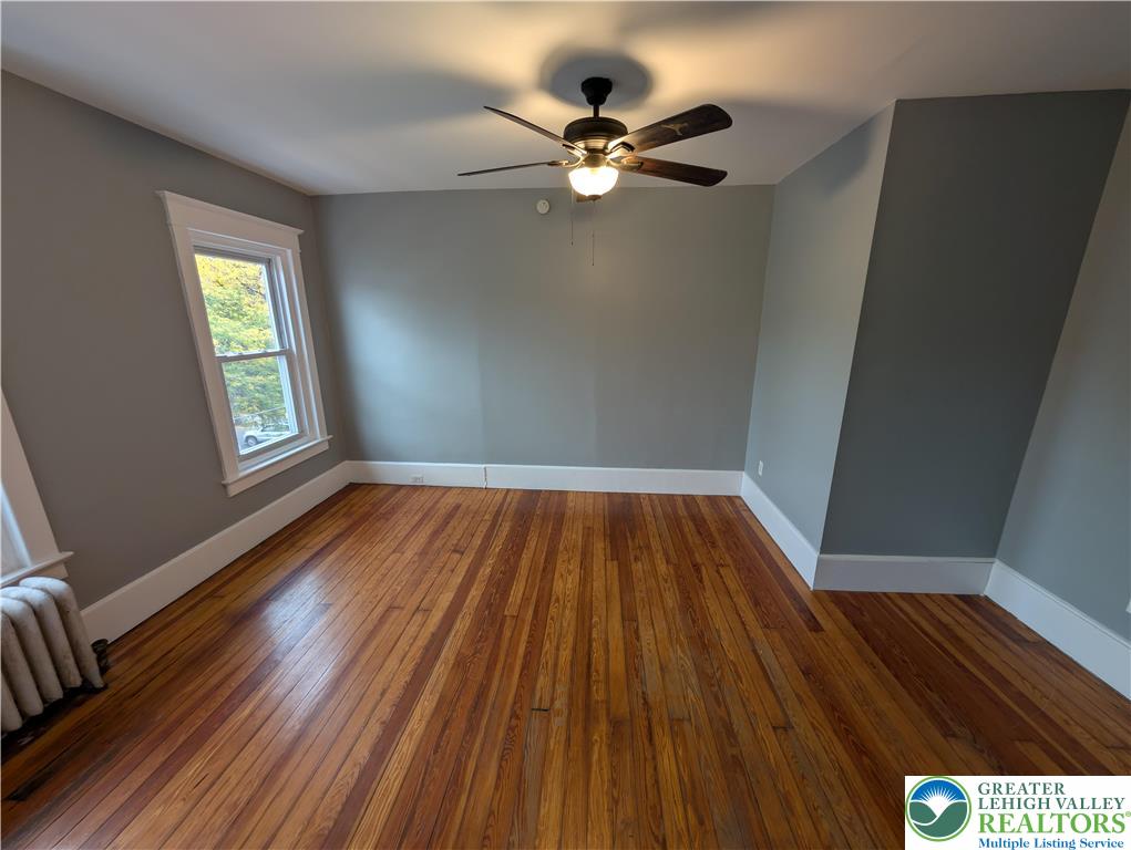 1027 Walnut Street, Unit 3 Allentown, PA 18102 - Photo 5 of 14 a view of an empty room with wooden floor and a window
